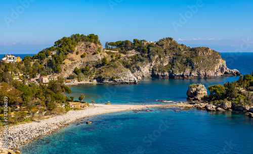 Panoramic view of Capo Taormina cape with Isola Bella island on Ionian sea shore in Messina region of Sicily in Italy © Art Media Factory