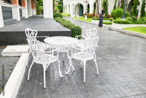 Classic white steel chair and table in the garden,empty white vintage chairs in the garden,decoration english garden concept. photo