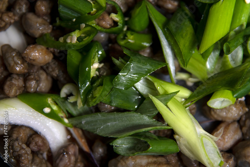 knife-cut green onions on the materials and ingredients for seafood stew