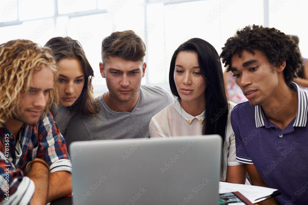 Fototapeta premium Group, students and reading together on laptop in classroom, assignment and online project in university. Young people, school and collaboration in college by computer and blog for academic research