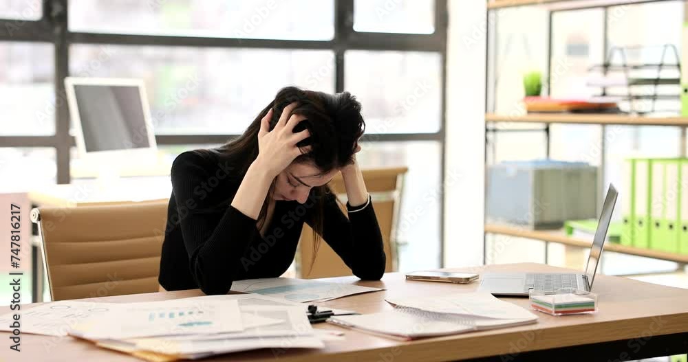Tired indian woman student throwing document on table and grabbing head 4k movie slow motion. Difficulties and problems in business education concept Tired indian woman student throwing document on table and grabbing head 4k movie slow motion. Difficulties and problems in business education concept