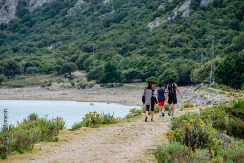 hikers walking on the road, Cúber reservoir, Escorca, Mallorca, Balearic Islands, Spain