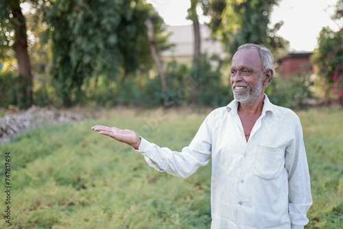 Indian happy farmer in a chickpea farm