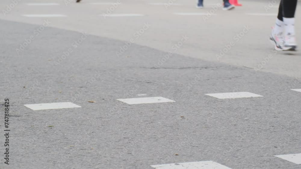Urban asphalt and legs of runners sport runs healthy lifestyle normal people of different ages and mostly women Urban asphalt and legs of runners sport runs healthy lifestyle normal people of different ages and mostly women