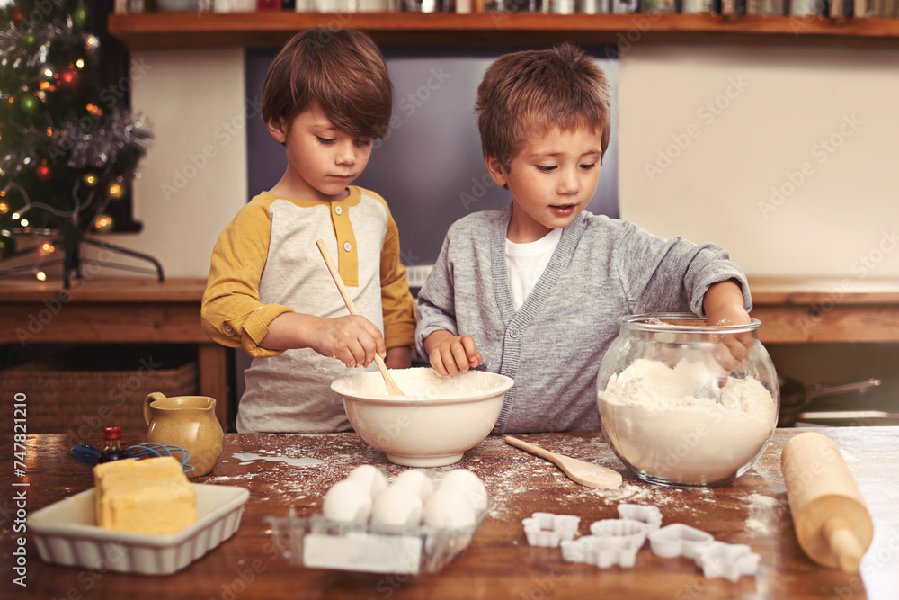 Kids, baking and playing in kitchen with flour, home and bonding with ingredients for dessert cake. Children, mixing and bowl for cookies on counter, eggs and boys learning of pastry recipe by butter Kids, baking and playing in kitchen with flour, home and bonding with ingredients for dessert cake. Children, mixing and bowl for cookies on counter, eggs and boys learning of pastry recipe by butter