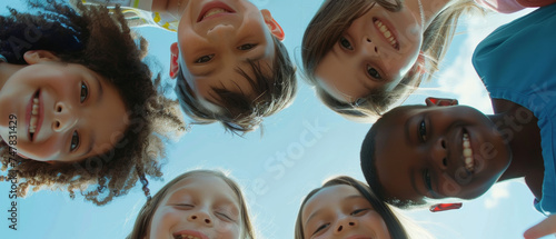 Cheerful group of diverse children looking down into the camera  beaming smiles.