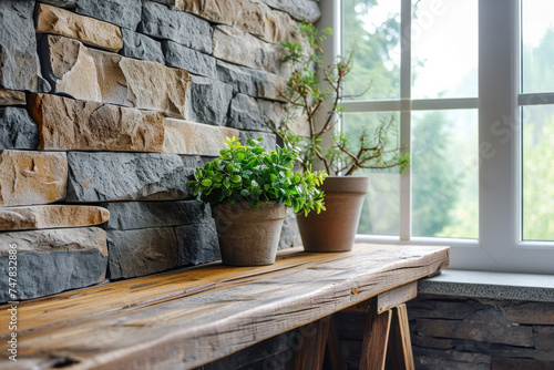 Potted plants on wooden ledge in modern stone wall interior. Home decoration and design. © Postproduction