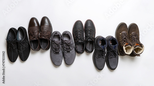 Men's shoes on white background. Pairs of men footwear for various seasons. Fashion collection of boots for man. Shoes store, advertising, shopping, sale concept. Flat lay, top view