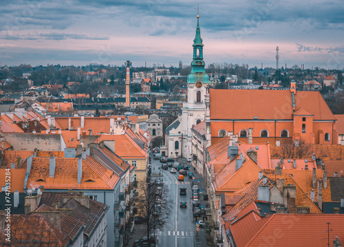 Urban landscape from a drone with a view of a church, city streets on a beautiful spring day with blue sky, a lot of architecture and infrastructure