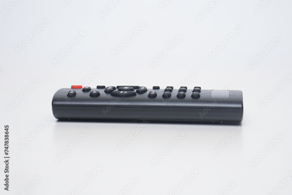 a black remote music player flat lay on a white background a black remote music player flat lay on a white background