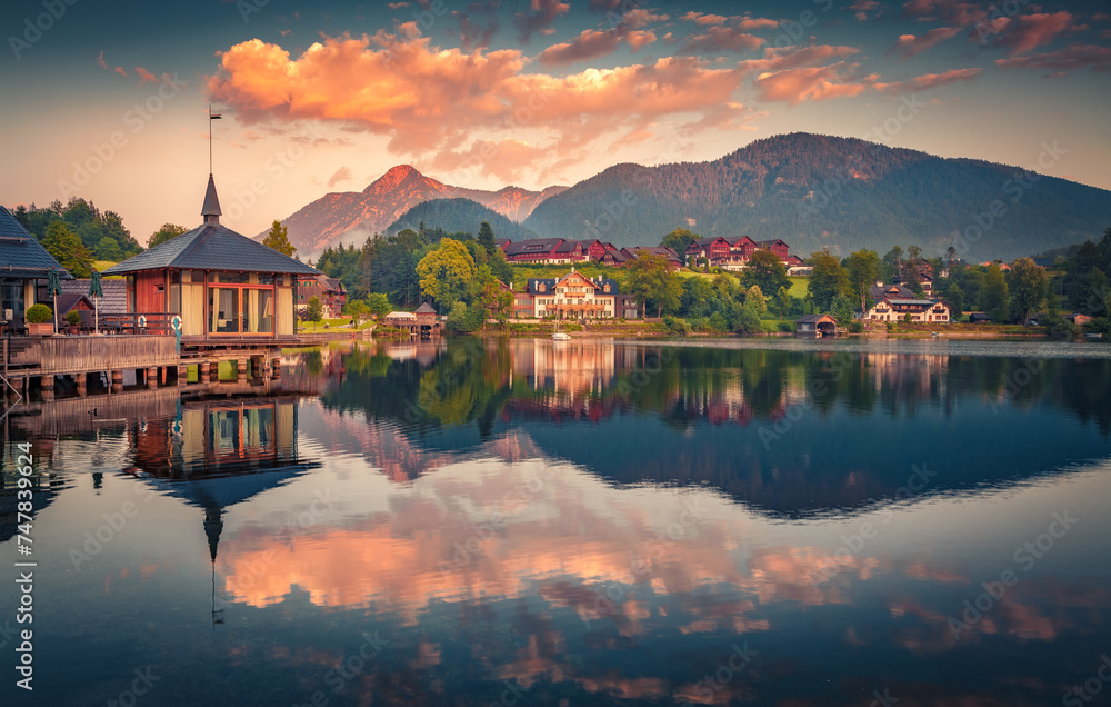Colorful summer sunrise on Grundlsee lake. Calm morning scene of Grundlsee village, Liezen District of Styria, Austria, Europe. Beauty of countryside concept background.