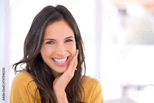 Portrait, laughing or happy woman in home to relax in living room on holiday in hotel, house or apartment. Face, joy or funny person with smile, wellness or confidence on break to rest for alone time
