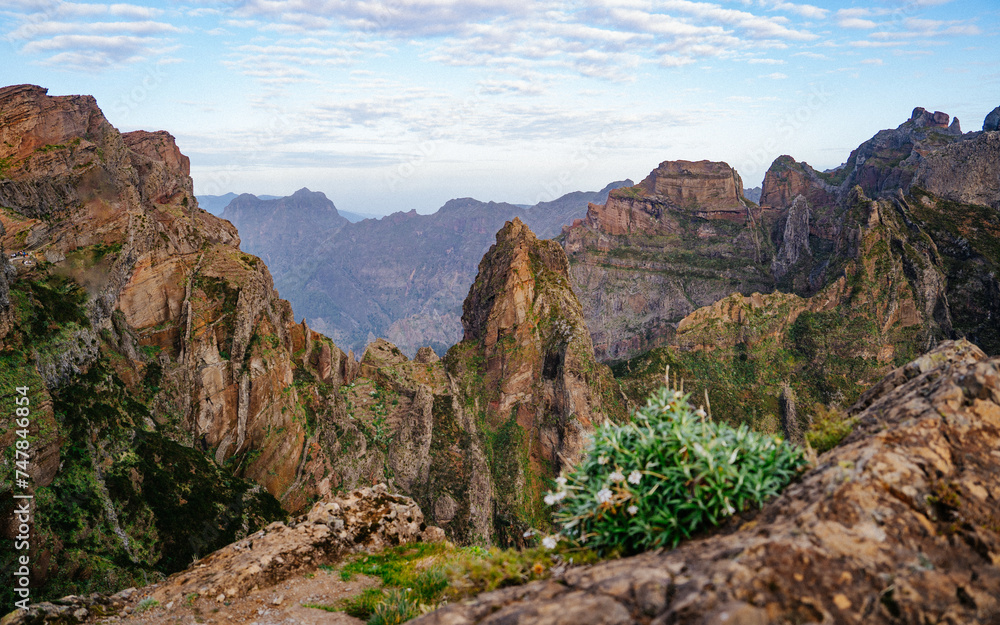 Beautiful hiking trail from Pico do Arieiro to Pico Ruivo, Madeira island. Footpath PR1 - Vereda do Areeiro. On summy summer day above the clouds. Portugal.