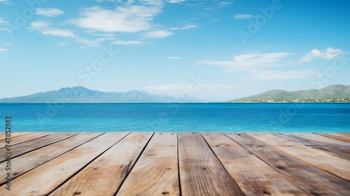 Serene Coastal Scene: Wooden Table Against Island Horizon & Azure Sky. Canon RF 50mm f/1.2L USM Capture © Nazia