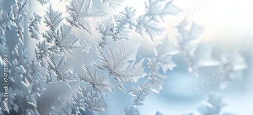 The delicate beauty of frost unfolds in intricate patterns against a backdrop of soothing blue hues © Murda