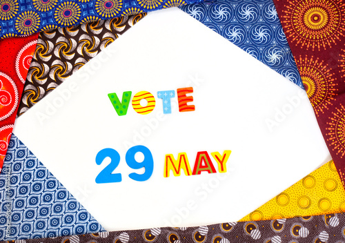 Vote 29 May on white with frame of mixed traditional South African Shwe Shwe fabric photo