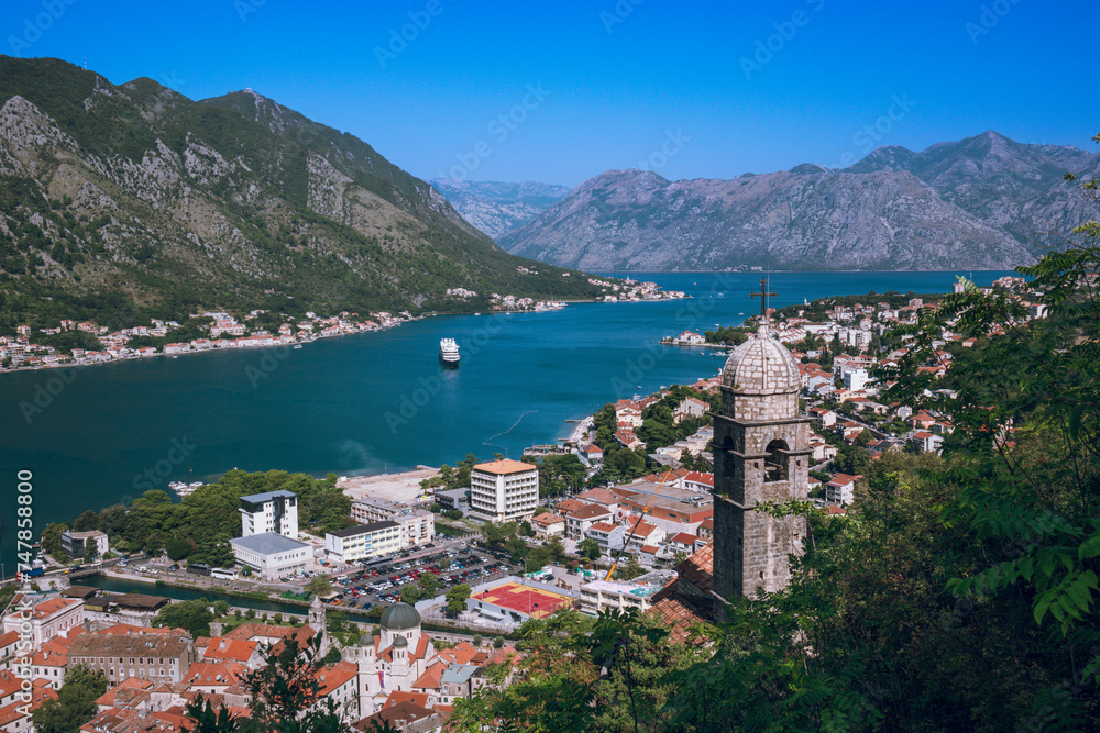 View of Kotor bay with the Bell tower of Church of Our Lady of Remedy on the slope of Saint John mountain