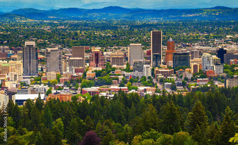 Aerial view of Portland, Oregon, showcasing urban skyline against forested hills. Photographed from Pittock Mansion viewpoint. Aerial view of Portland, Oregon, showcasing urban skyline against forested hills. Photographed from Pittock Mansion viewpoint.