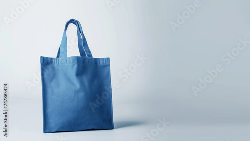 Pristine blue tote bag on a neutral background, symbolizing eco-friendly fashion.