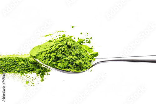 A spoonful of vibrant matcha powder on a white background