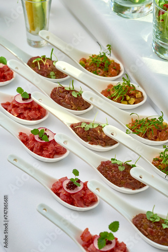 Appetizer for the banquet - different types of salmon  beef and tuna tartare on the table