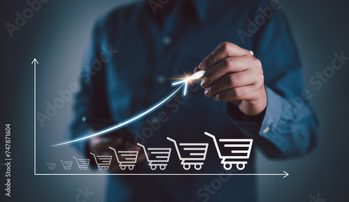 Εκτύπωση καμβά Businessman drawing increasing trend graph of sale volume with bigger shopping trolley cart for online sale business growth concept