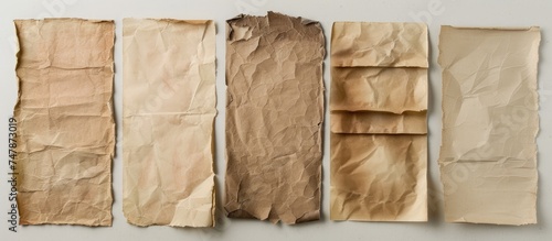 This image showcases a group of four pieces of brown paper with torn edges and visible folds. Each piece has a distinct texture, creating a nostalgic and vintage feel. The papers are arranged in a © TheWaterMeloonProjec