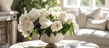 A vase filled with white flowers is placed on an elegant stone table. The arrangement creates a timeless and classic display, bringing a touch of beauty to the room.