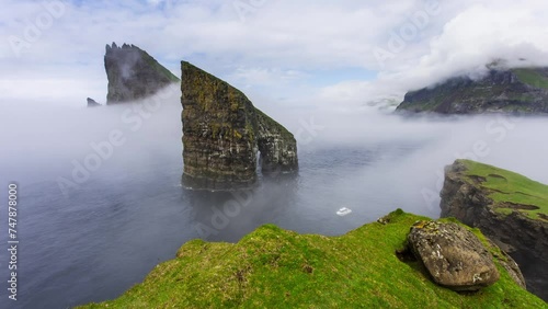 Faroe Island - Time lapse of atlantic ocean and coast cliff, Drangarnir, Denmark photo