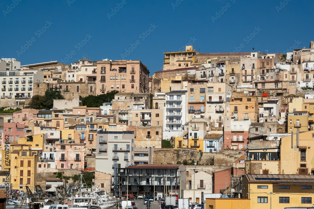 Sciacca, Sicily, Italy The old fishing port and harbor with fishing boats and skyline with old houses.