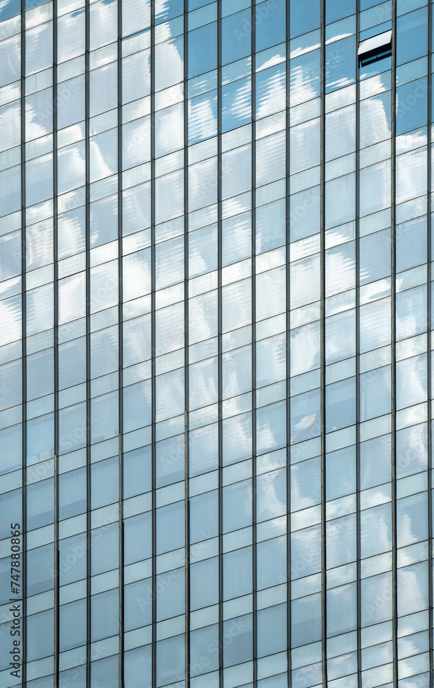 windows of modern office building exterior reflects cloudy sky. windows of modern office building exterior reflects cloudy sky.