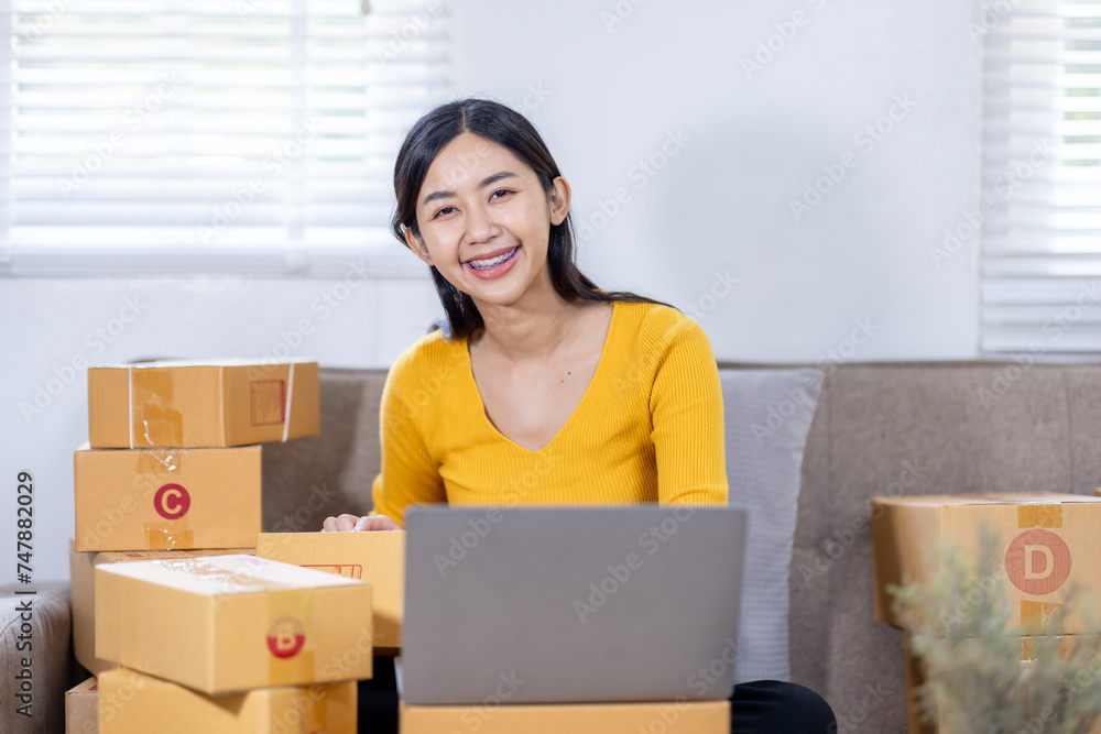 Startup small business entrepreneur SME freelance woman working with box, Young Asian small business owner office online market packing delivery, SME delivery e-commerce telemarketing seller concept Startup small business entrepreneur SME freelance woman working with box, Young Asian small business owner office online market packing delivery, SME delivery e-commerce telemarketing seller concept
