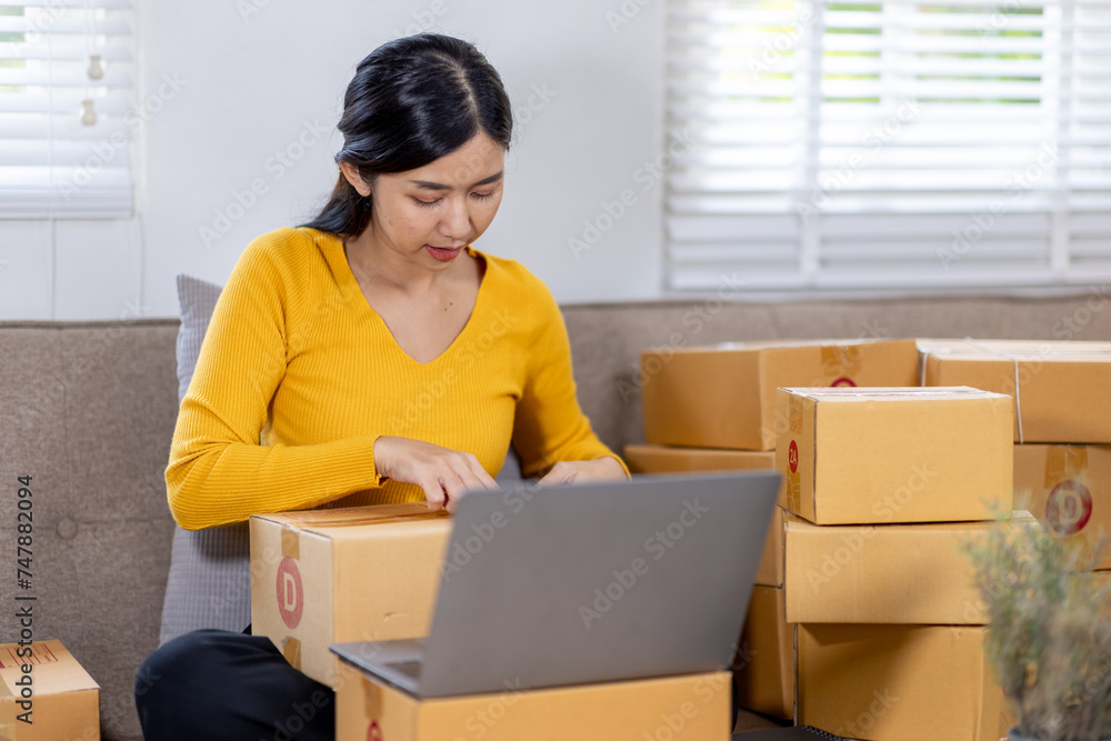 Startup small business entrepreneur SME freelance woman working with box, Young Asian small business owner office online market packing delivery, SME delivery e-commerce telemarketing seller concept Startup small business entrepreneur SME freelance woman working with box, Young Asian small business owner office online market packing delivery, SME delivery e-commerce telemarketing seller concept