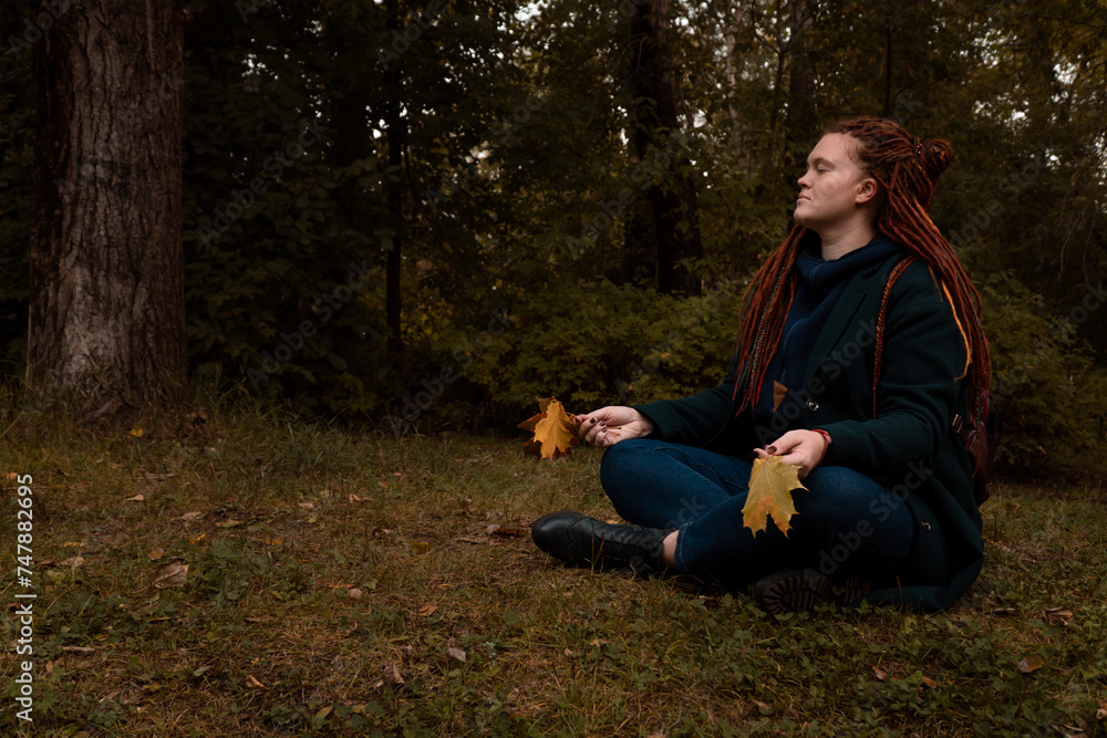 woman doing meditation in forest alone woman doing meditation in forest alone