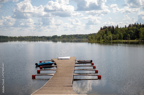 Wooden jetty on the lake in summer. Lake landscape.