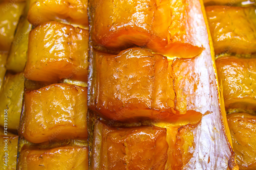 Balyk from smoked sturgeon in selective focus on a market counter.Source of Omega-3 Fats.Sale of fresh fish. Balyk from smoked sturgeon in selective focus on a market counter.Source of Omega-3 Fats.Sale of fresh fish.