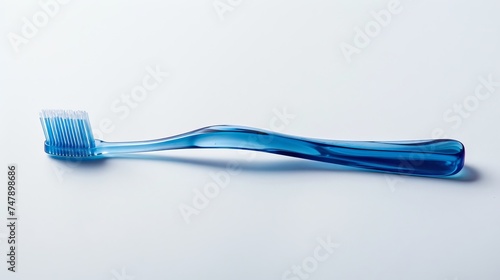 A blue plastic toothbrush captured in top view, sideways, and lengthwise orientations against a white background