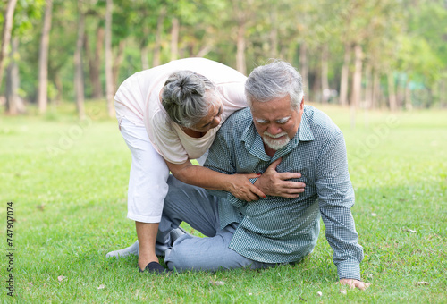 asian senior man fell down and having chest pain from heart attack in the park © offsuperphoto