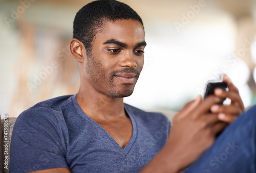 Home, relax and black man with smartphone, typing and connection with social media and internet. African person, apartment and guy with cellphone and digital app with mobile user and online reading