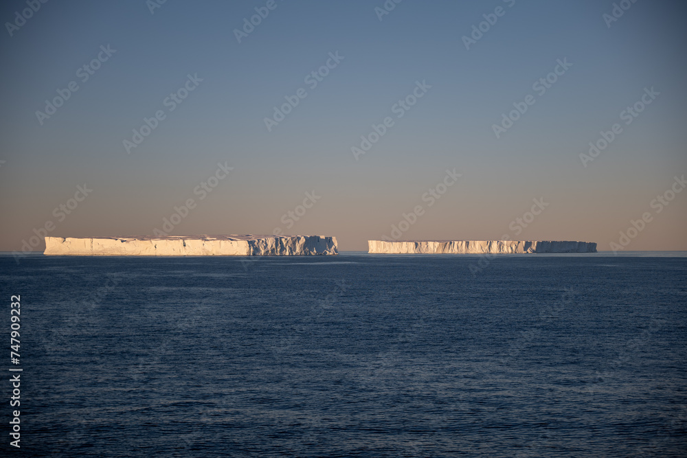Two tabular iceberg during sunset in Antarctica
