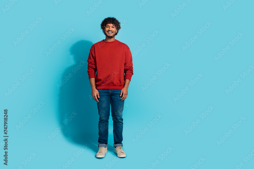 Full size portrait of cheerful attractive man strand posing empty space advert isolated on blue color background Full size portrait of cheerful attractive man strand posing empty space advert isolated on blue color background