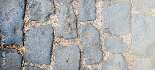 Granite cobblestoned pavement background on sunlight