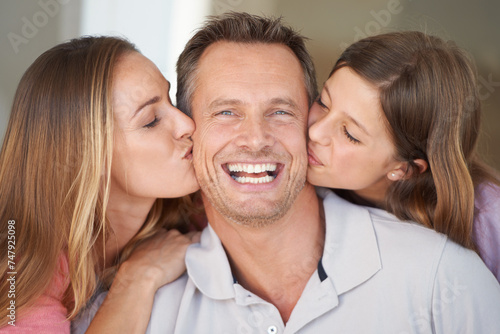 Mom, dad and girl in portrait with kiss, relax and happy bonding together in family home. Celebration, parents and daughter with smile on fathers day with love, fun and care with man, woman and child