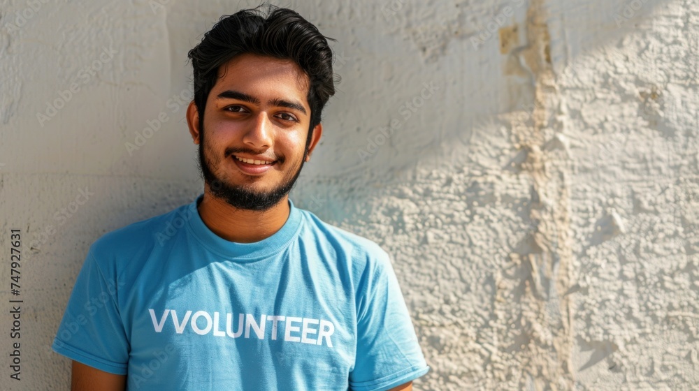 Young man with a beard wearing a blue t-shirt with the word Young man with a beard wearing a blue t-shirt with the word