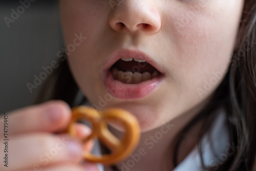 Girl Eating German Pretzel  Close-Up