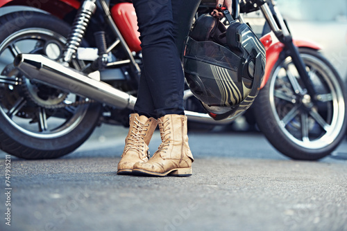 Fototapeta Naklejka Na Ścianę i Meble -  Legs, road and person with a motorcycle for urban journey and commute in Prague, Europe. Riding, break and people with feet closeup for motorbike commute in the Czech Republic with confidence