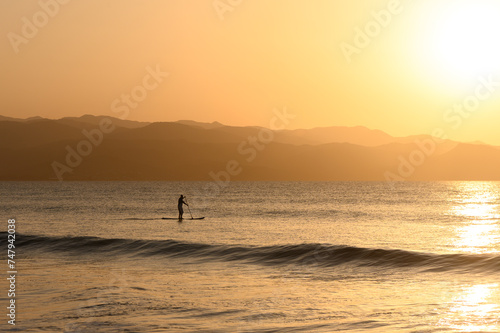 SUP boarding lesson on the Mediterranean sea in winter at sunset 4
