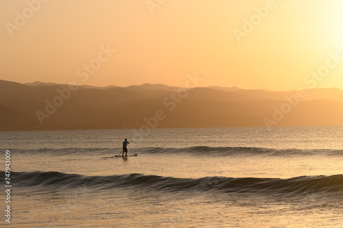 SUP boarding lesson on the Mediterranean sea in winter at sunset 5