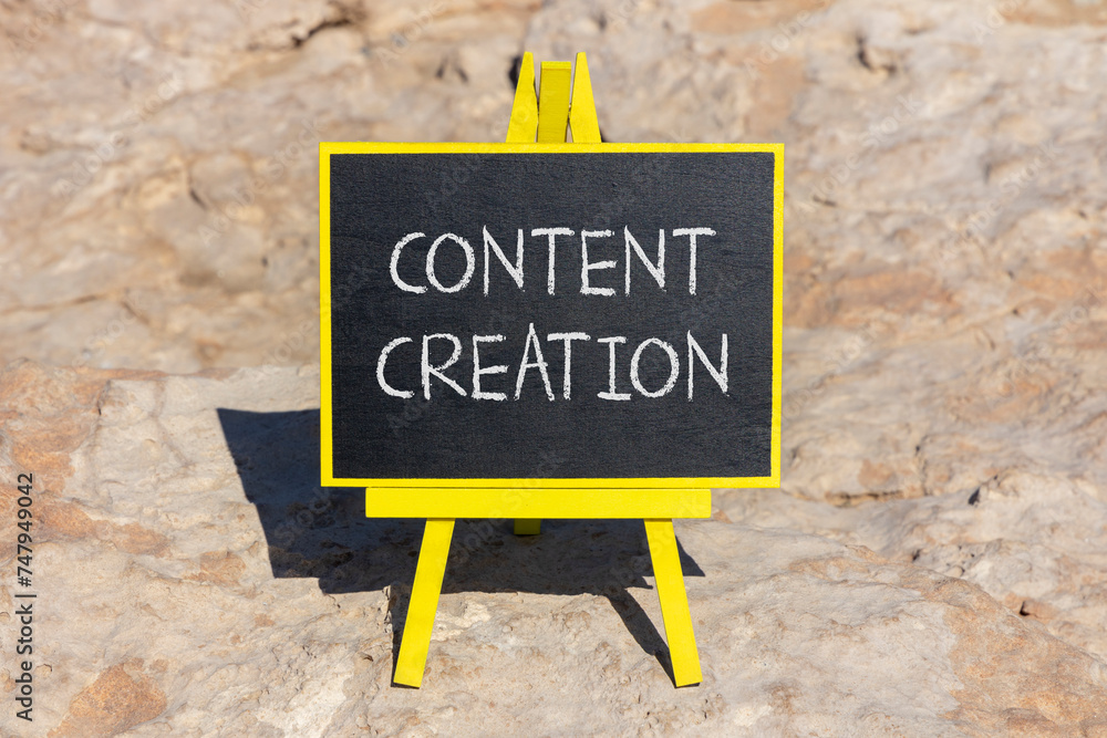 Fototapeta premium Time for content creation symbol. Concept words Content creation on beautiful black blackboard. Beautiful stone beach background. Business time for content creation concept. Copy space.