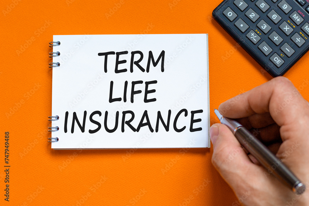 Term life insurance symbol. Concept words Term life insurance on beautiful white note. Beautiful orange background. Businessman hand. Calculator. Medical term life insurance concept. Copy space. Term life insurance symbol. Concept words Term life insurance on beautiful white note. Beautiful orange background. Businessman hand. Calculator. Medical term life insurance concept. Copy space.